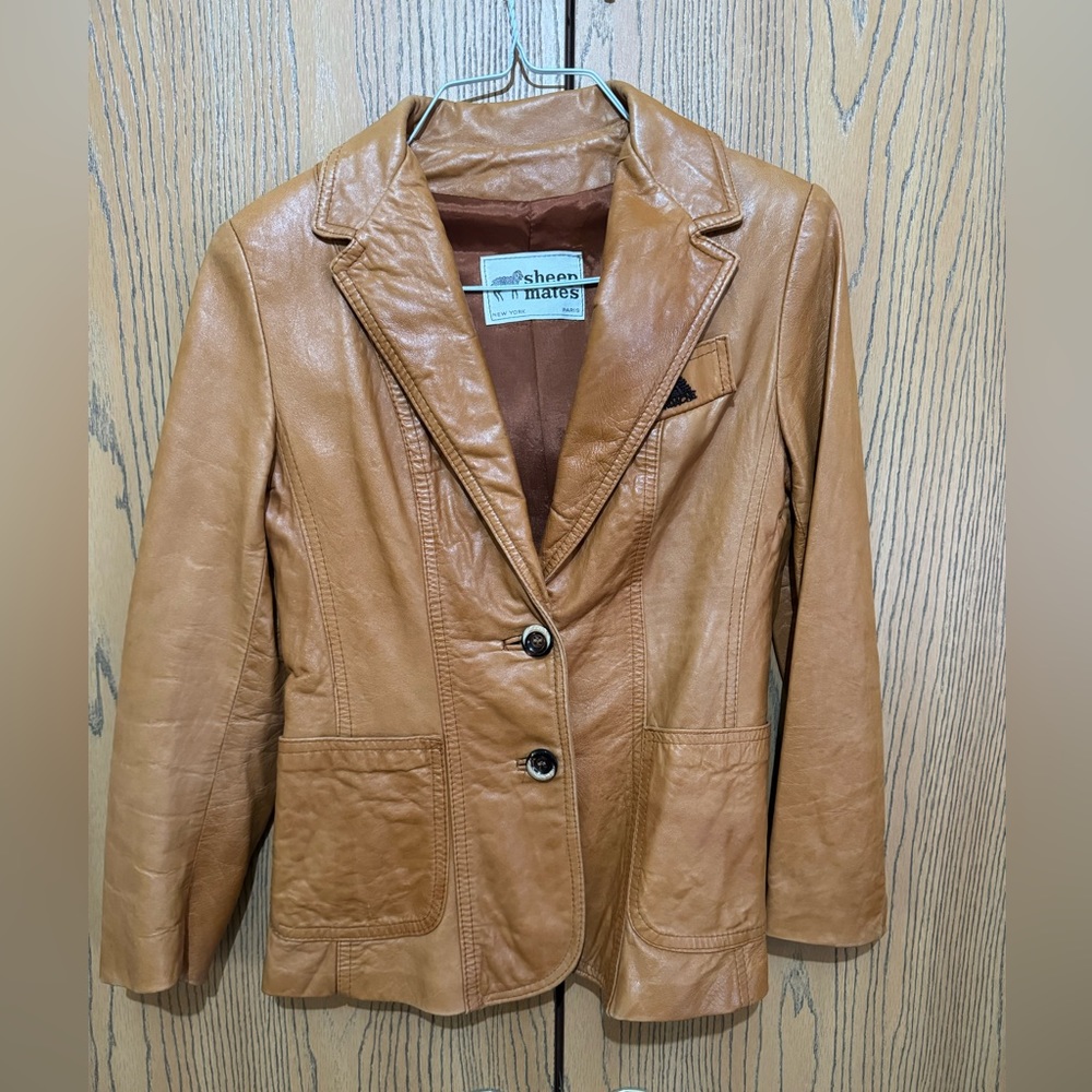 Jordache leather jacket. Torn left sleeve cuff. Sheep Mates New York Paris